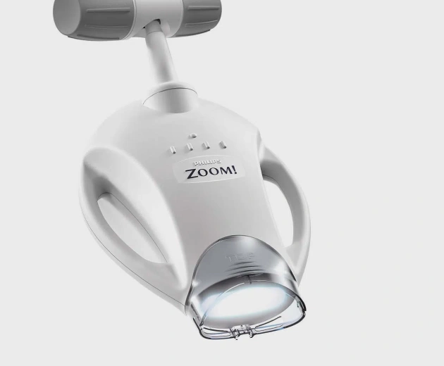 Zoomi intraoral camera mounted on dental chair for detailed tooth examination and patient education.