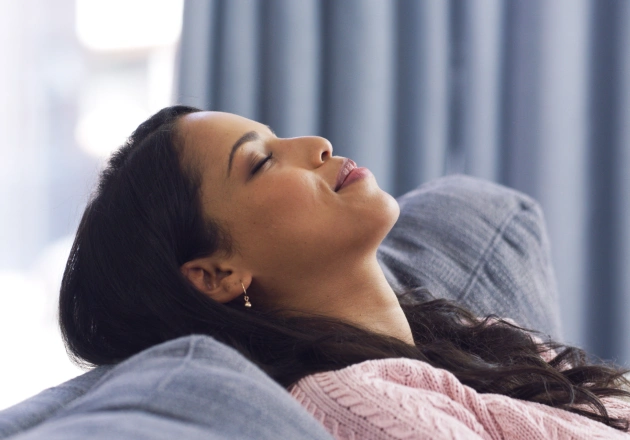 Woman relaxing in dental chair during treatment at modern dental office