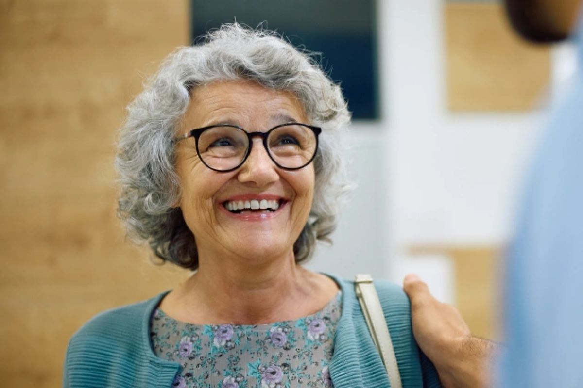 Senior woman happy about Invisalign insurance coverage
